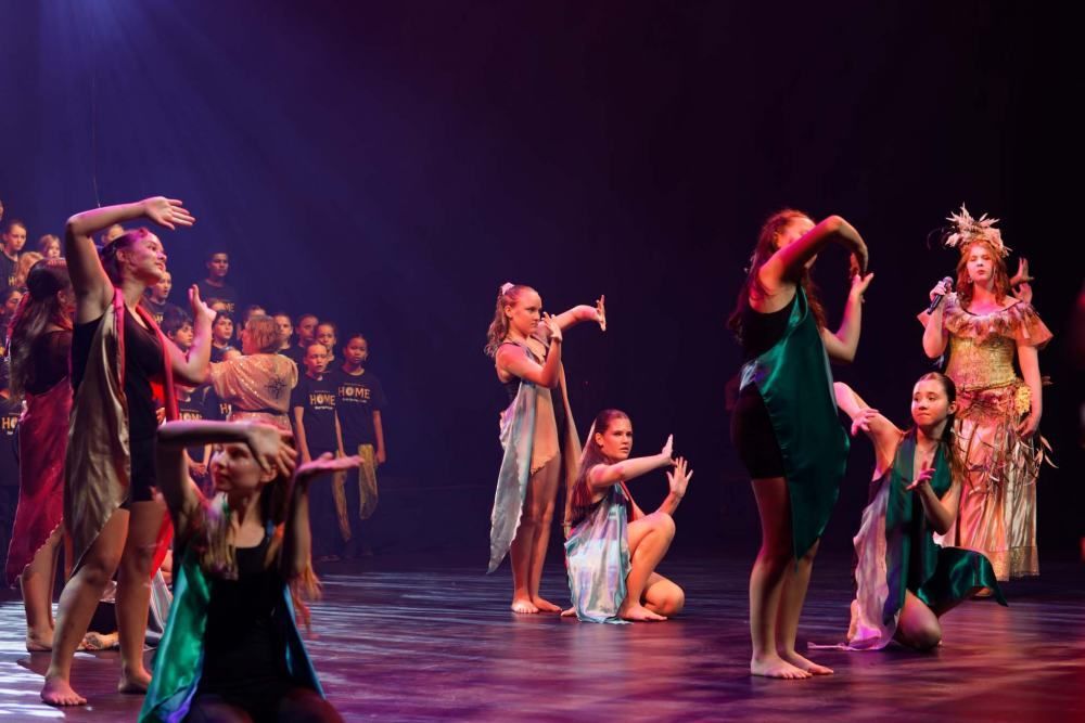 A group of young women are dancing on a stage.