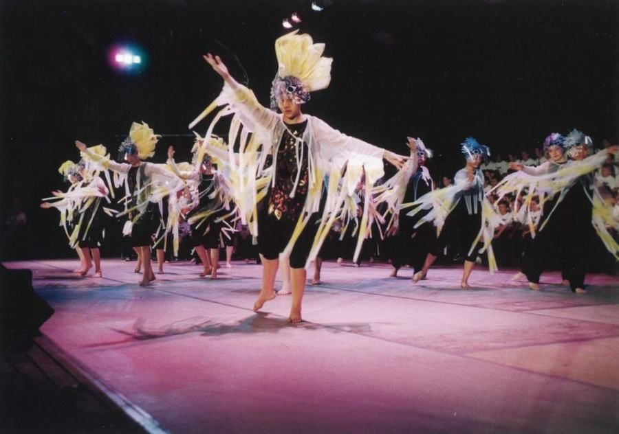 A group of people are dancing on a stage.