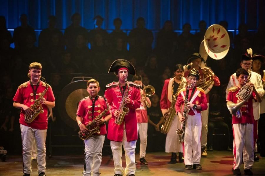 A group of people are playing instruments on a stage.