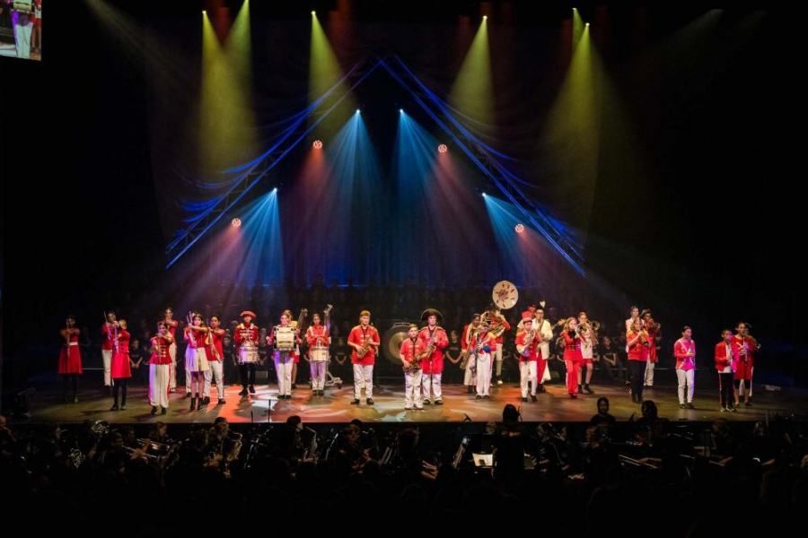 A band is playing on a stage in front of a crowd.
