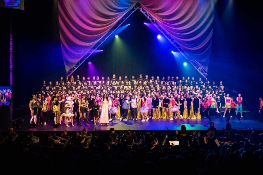 A large group of people are standing on a stage.