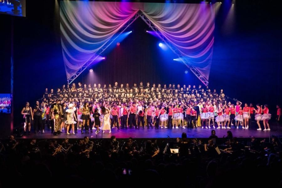 A large group of people are standing on a stage.