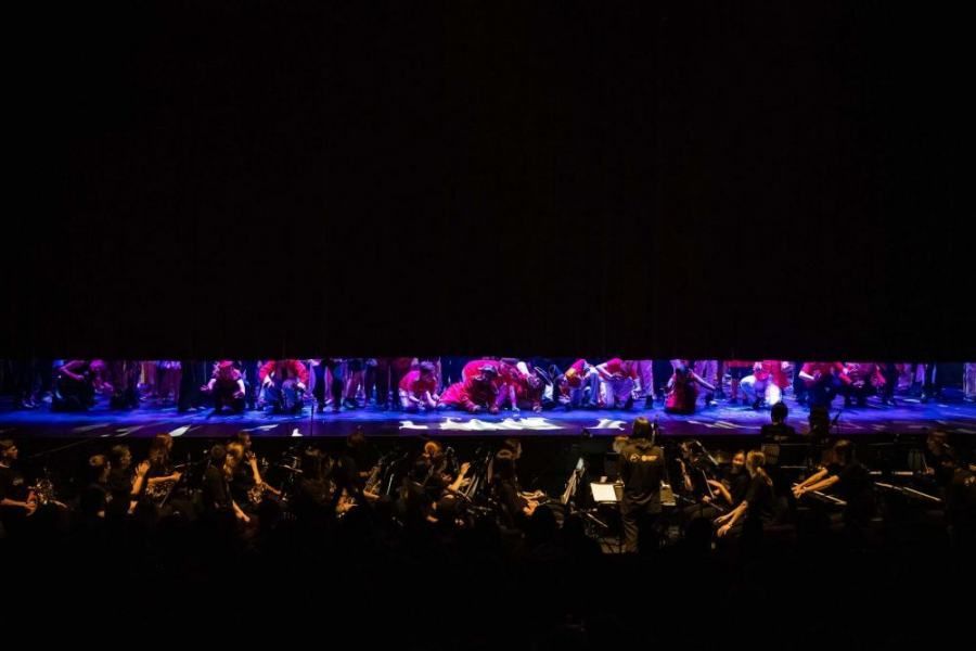 A crowd of people are watching a performance on a stage.