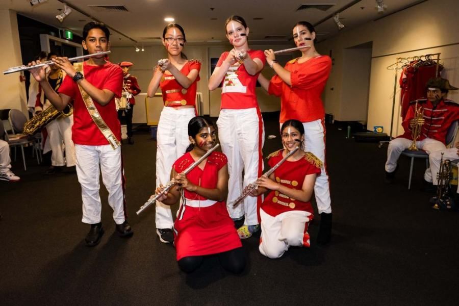 A group of young people are playing flutes in a band.