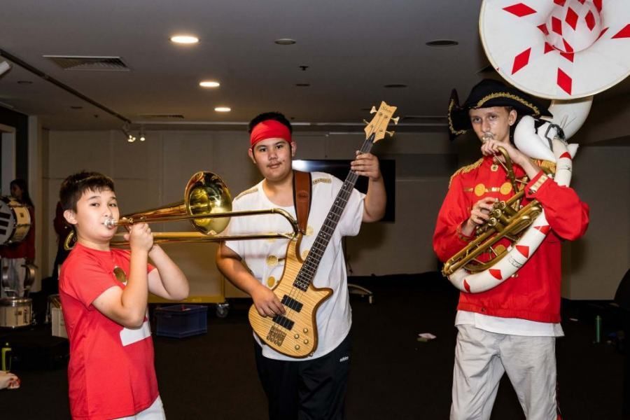 A group of young men are playing instruments in a band.