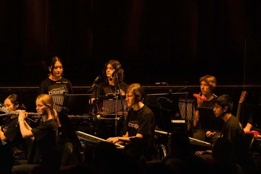 A group of people are playing instruments on a stage.