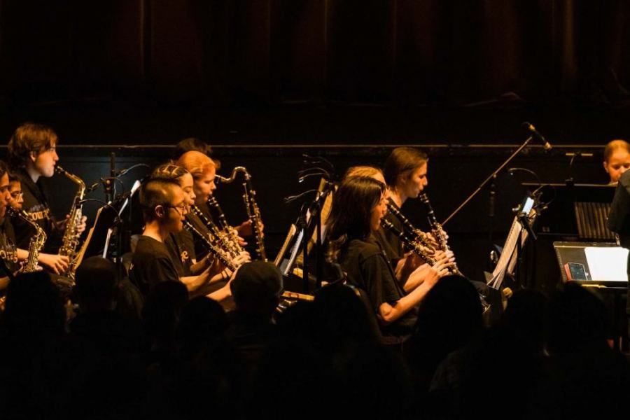 A group of people are playing instruments on a stage.