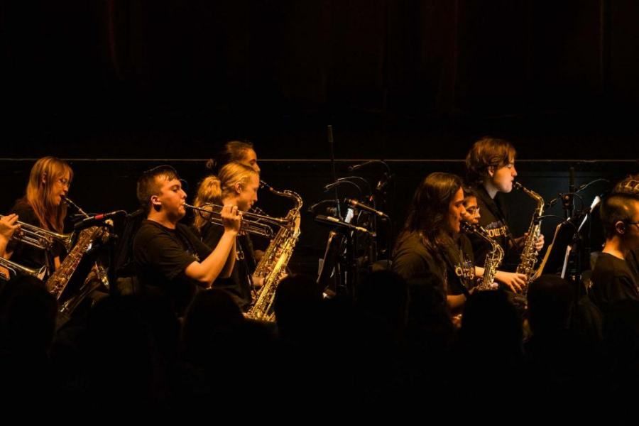 A group of people are playing instruments on a stage.
