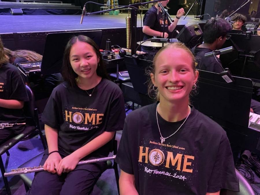 Two girls wearing black shirts with the word home on them
