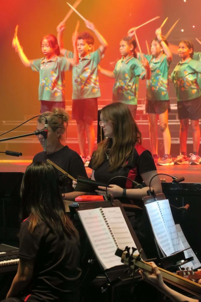 A group of people are playing instruments on a stage.