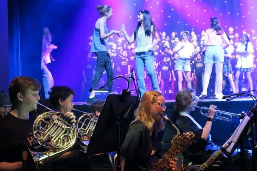 A group of people are playing instruments on a stage.