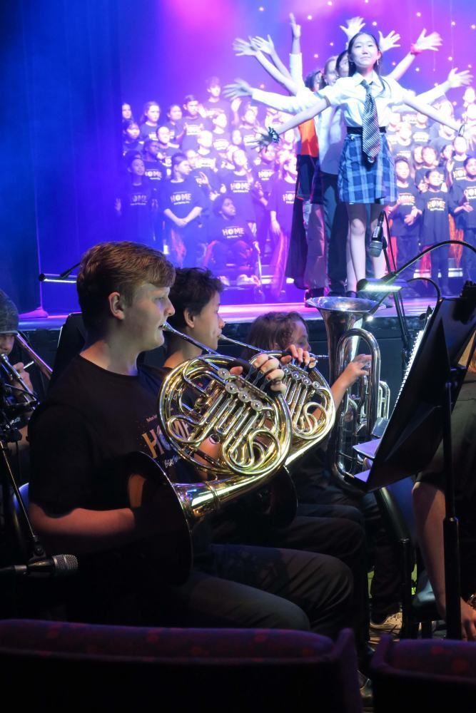 A group of people are playing instruments on a stage.