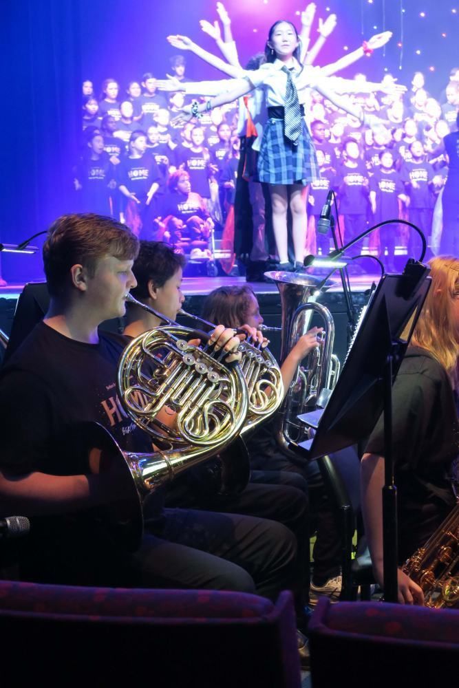 A group of people are playing instruments on a stage.