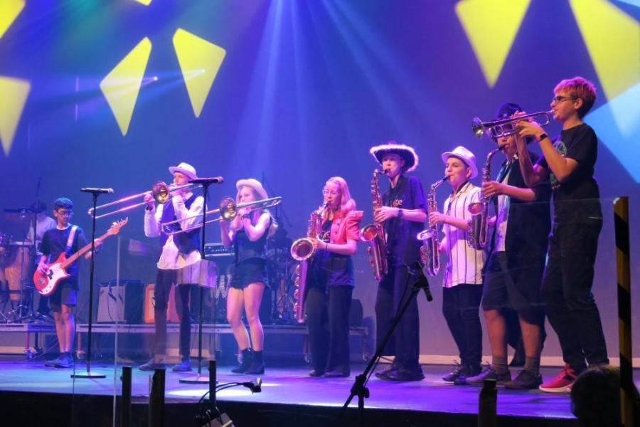 A group of people are playing instruments on a stage.