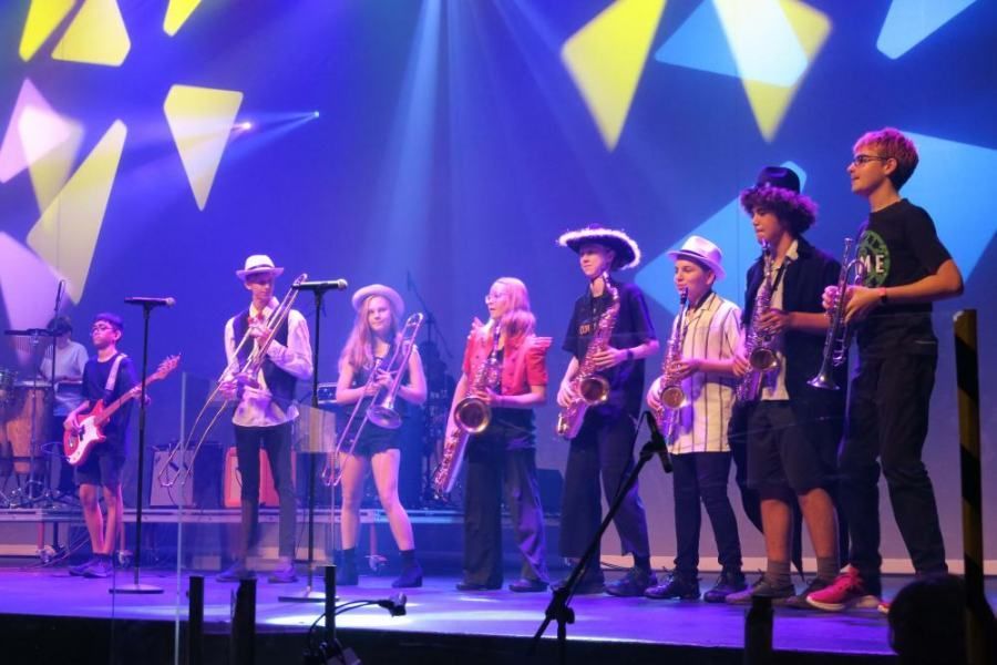 A group of people playing instruments on a stage