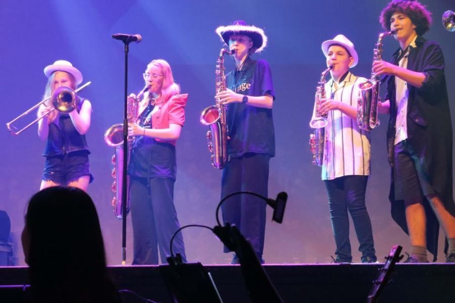 A group of people playing instruments on a stage