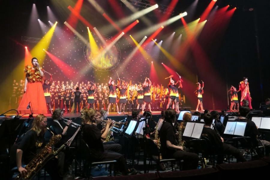 A group of people are playing instruments on a stage.