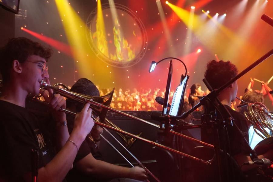 A group of people are playing trombones on a stage.