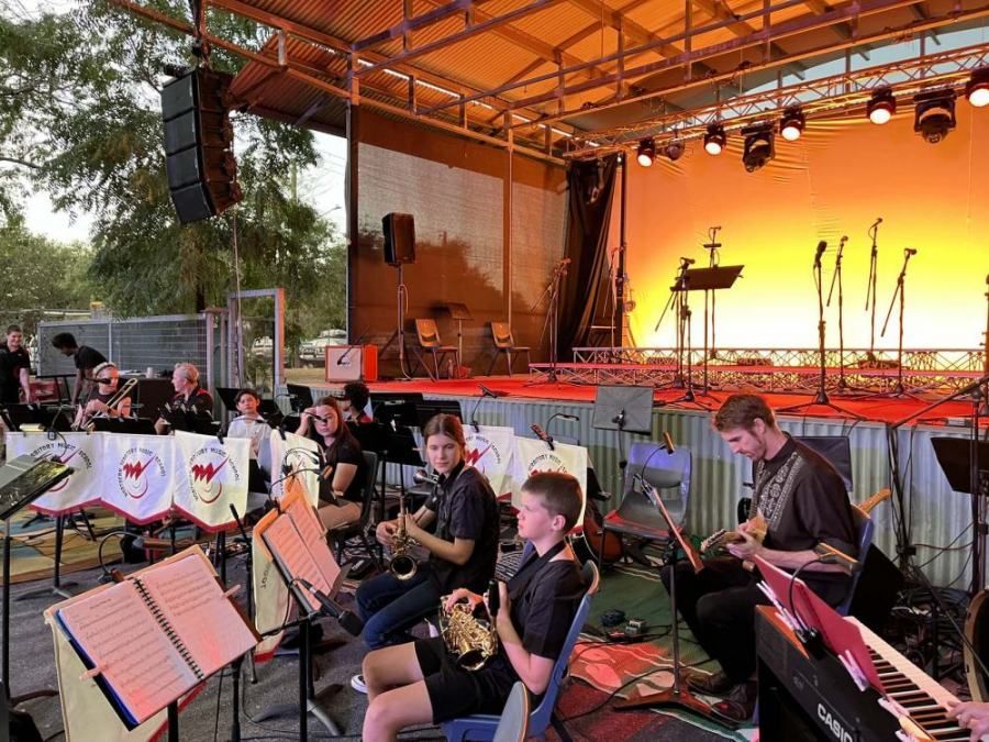 A group of people are playing instruments on a stage.
