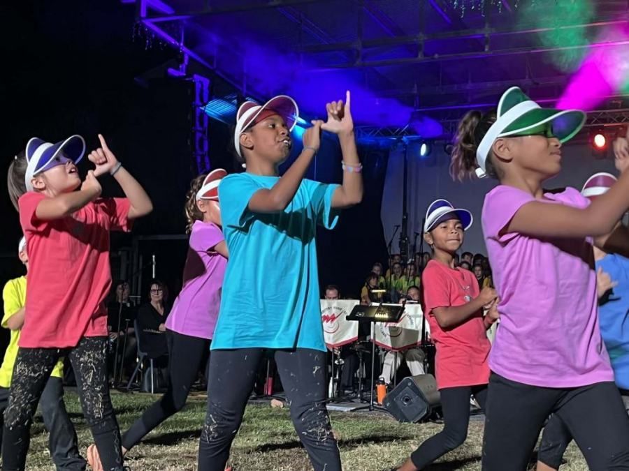 A group of young girls are dancing on a stage.