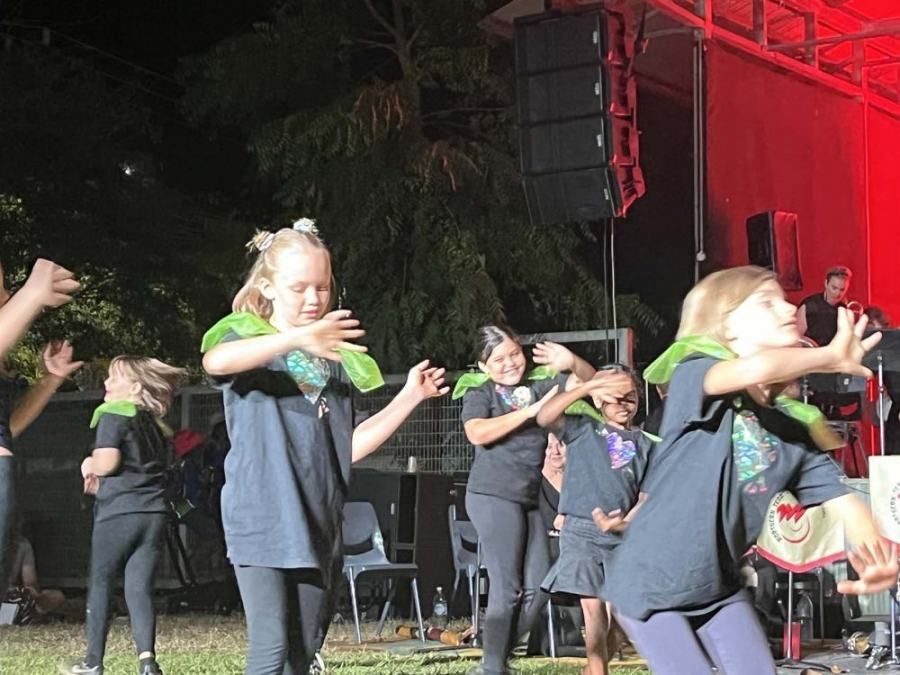 A group of young girls are dancing on a stage.