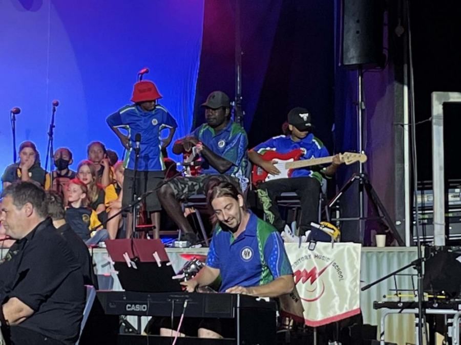 A group of people are playing instruments on a stage.