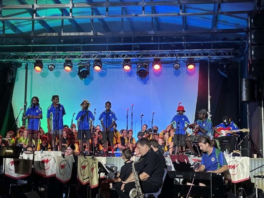 A group of people are playing instruments on a stage