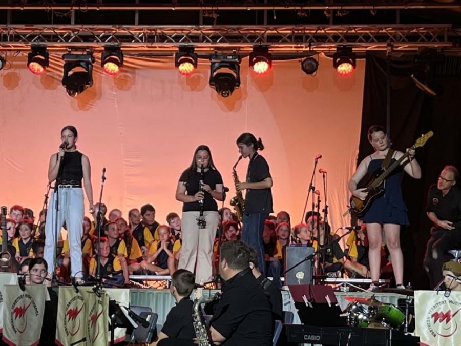 A group of people are playing instruments on a stage