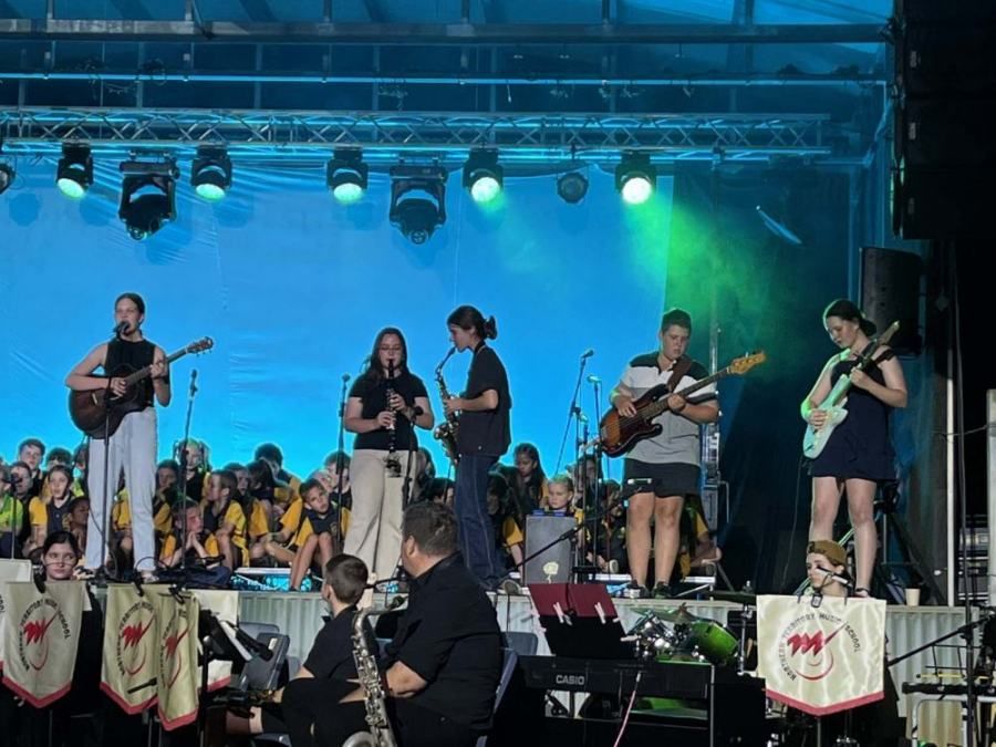 A group of people are playing instruments on a stage.