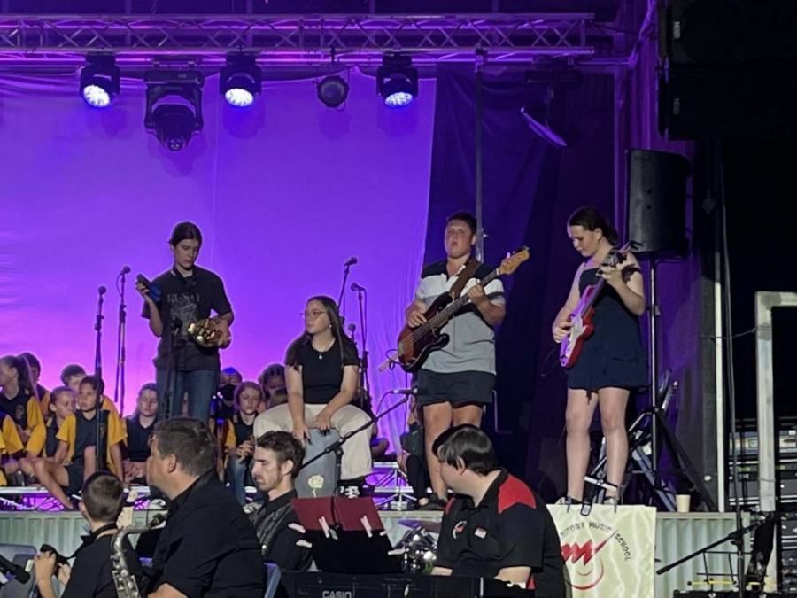 A group of people are playing instruments on a stage.