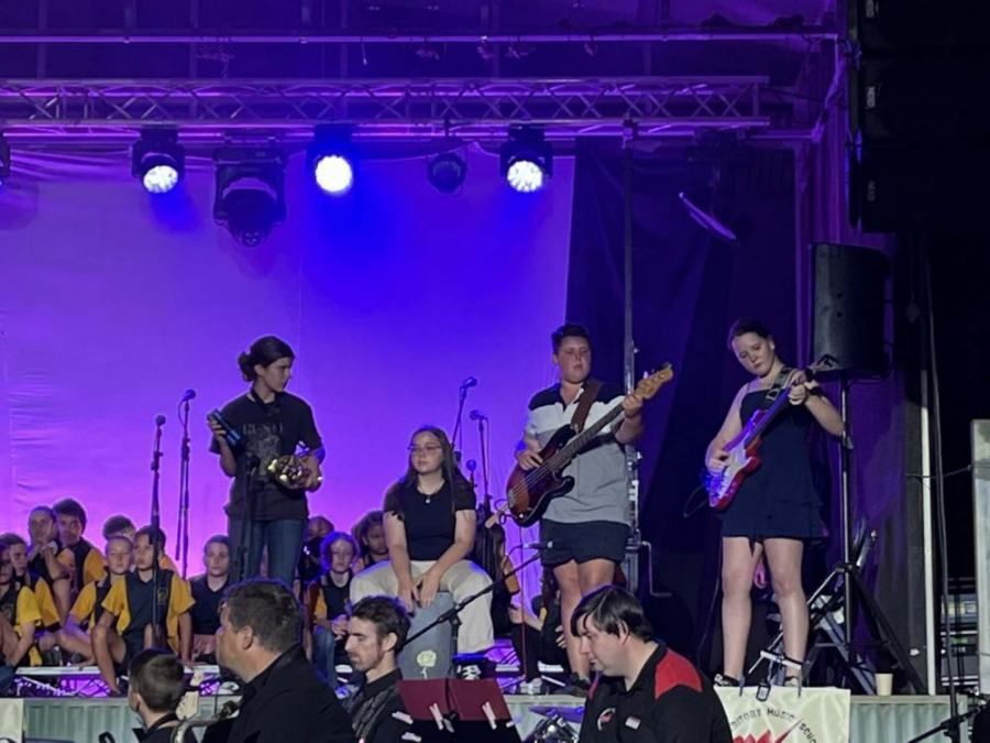 A group of people are playing instruments on a stage.