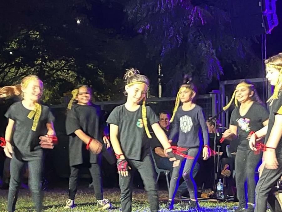 A group of young girls are dancing on a stage.