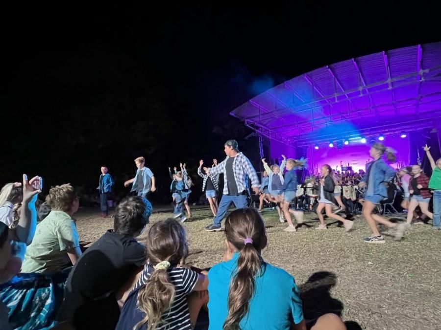 A group of people are watching a group of people dancing on a stage.