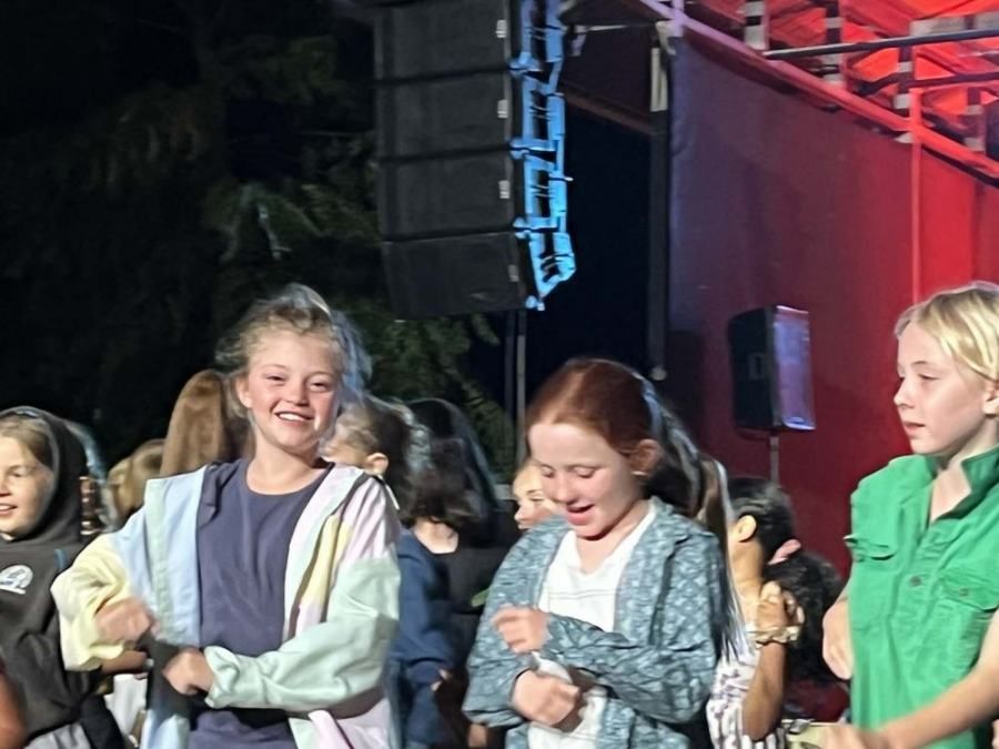 A group of young girls are standing next to each other