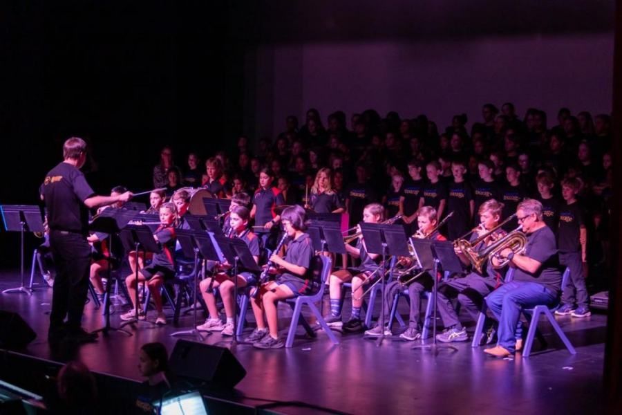 A group of people are playing instruments on a stage.