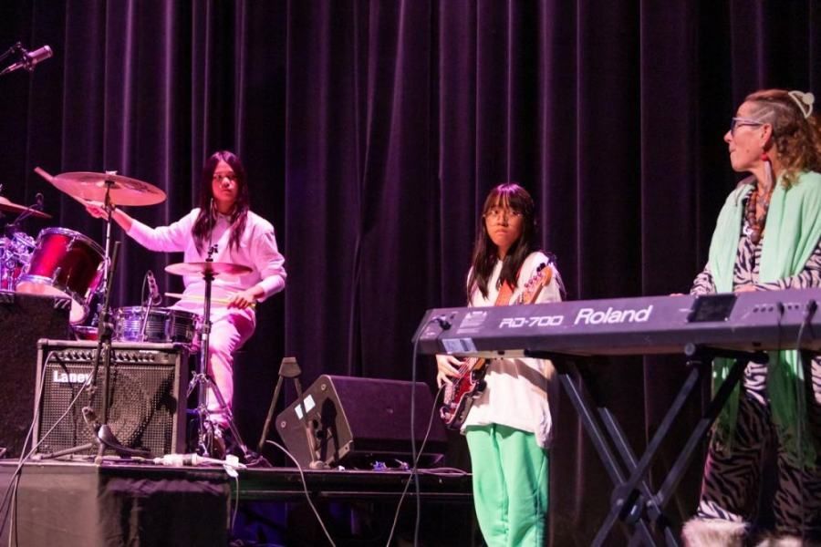 A group of people are playing instruments on a stage.