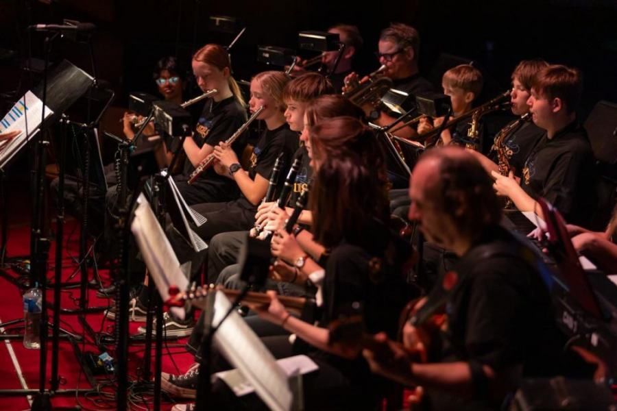 A group of people are playing instruments on a stage.