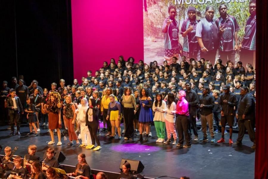 A large group of people are standing on a stage.