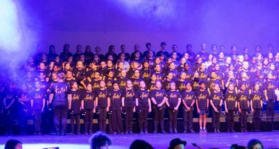 A large group of people are standing on a stage.