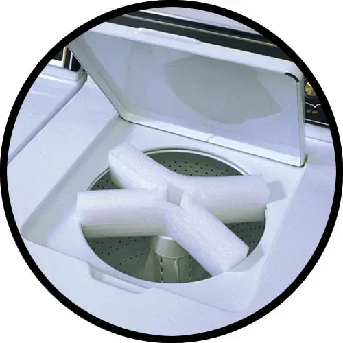 Open washing machine with styrofoam packing inside.