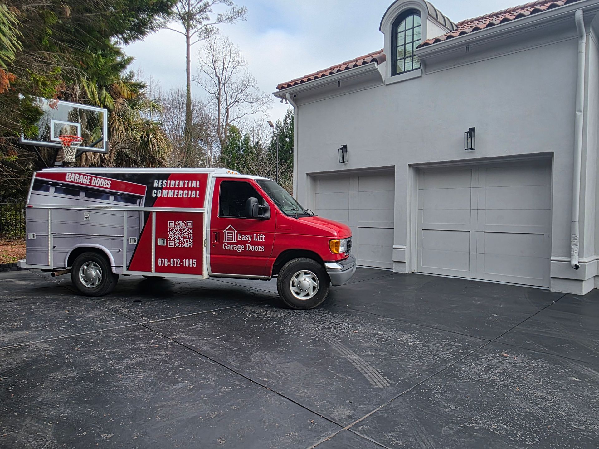 Townhomes with brick and beige facades, tan garage doors, and concrete driveways on a cloudy day.