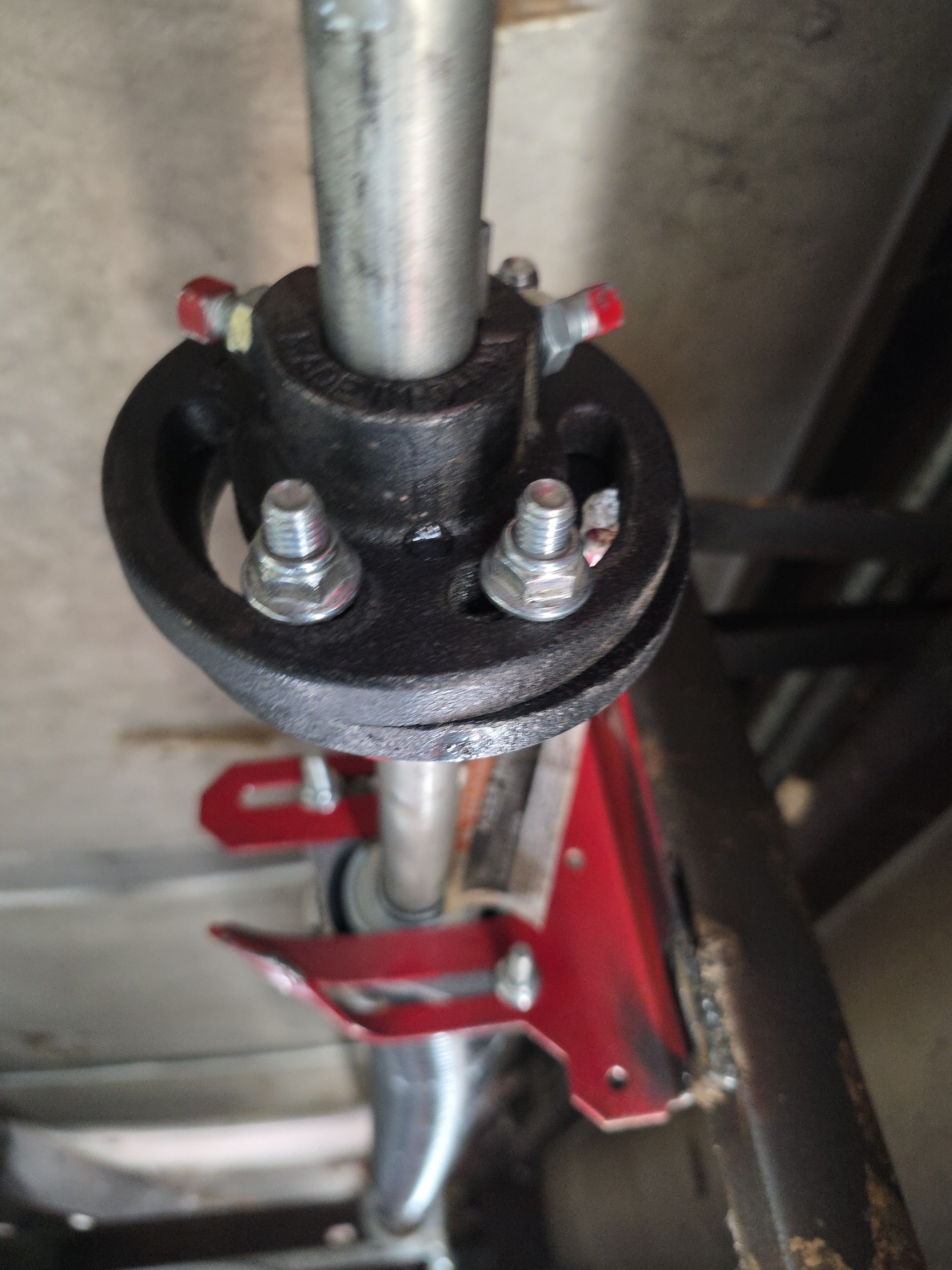 Two grey doors set in a grey wall, in front of grass, with a corrugated white metal background.