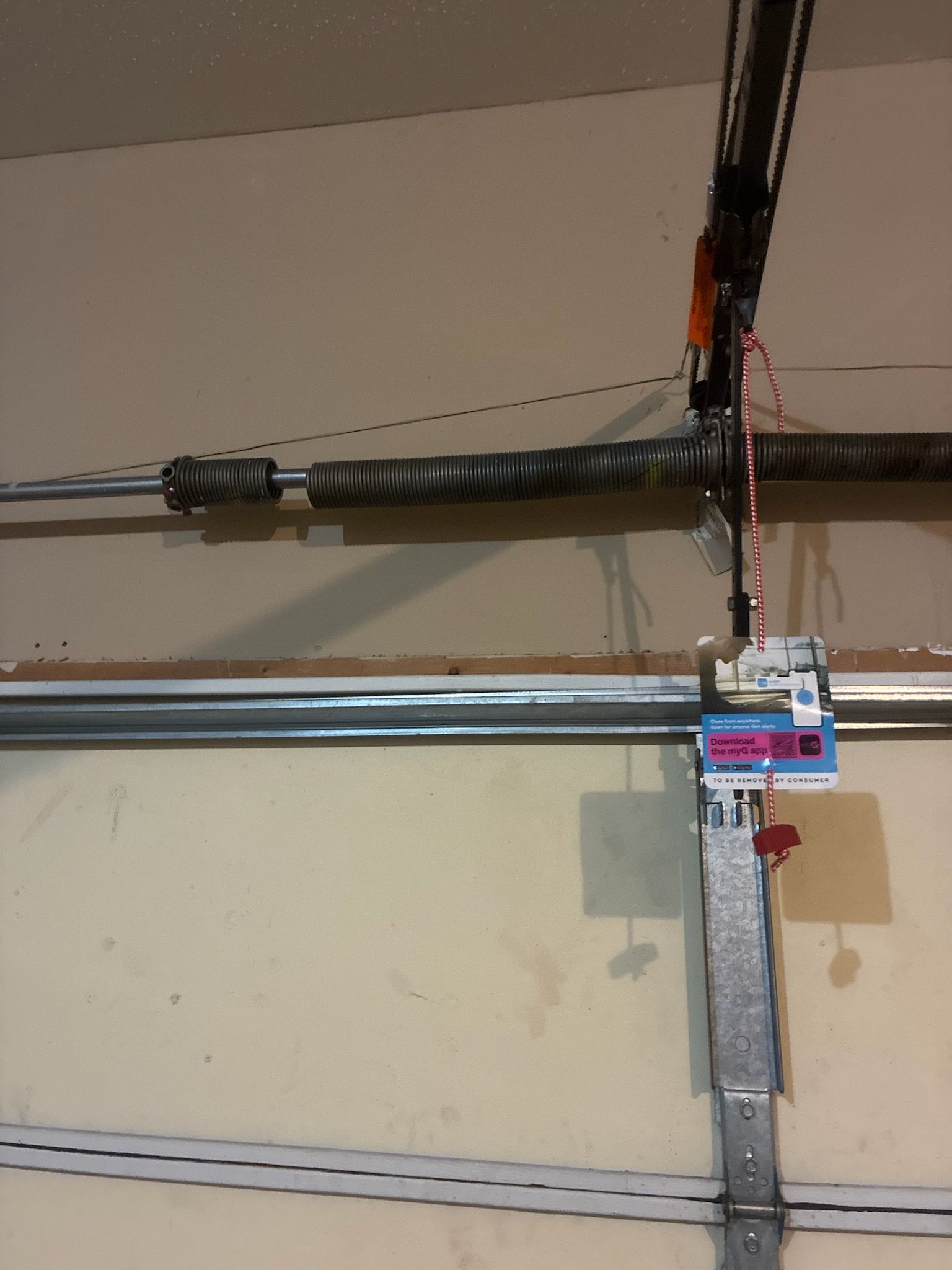 Gray garage door with arched windows and black hardware.