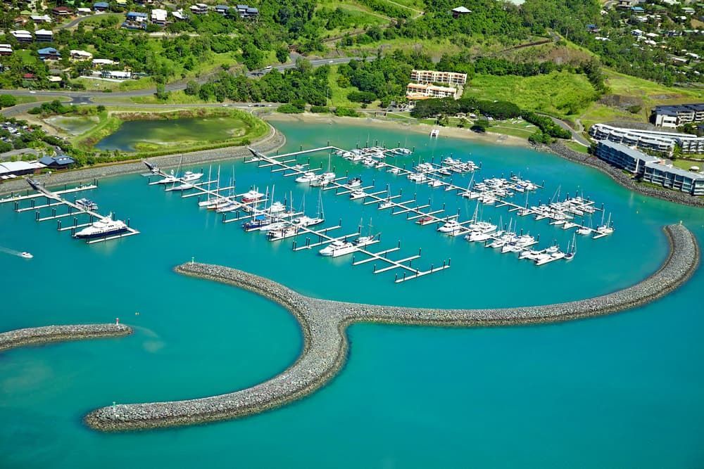 An Aerial View of A Marina with Boats Docked in The Water — New Park Suit Hire & Menswear in Airlie Beach, QLD