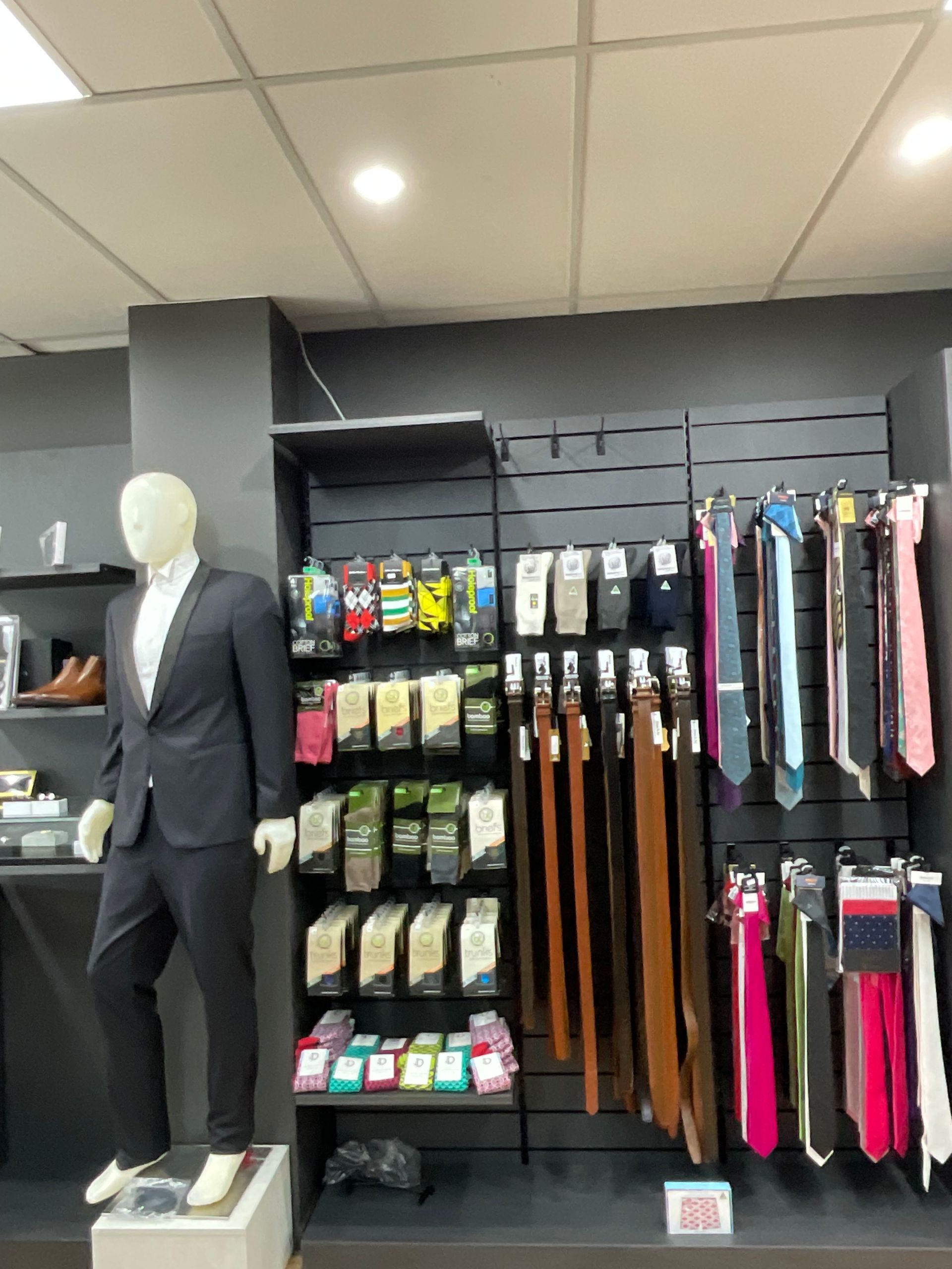 A Mannequin next to a display of ties — New Park Suit Hire & Menswear in Mackay, QLD