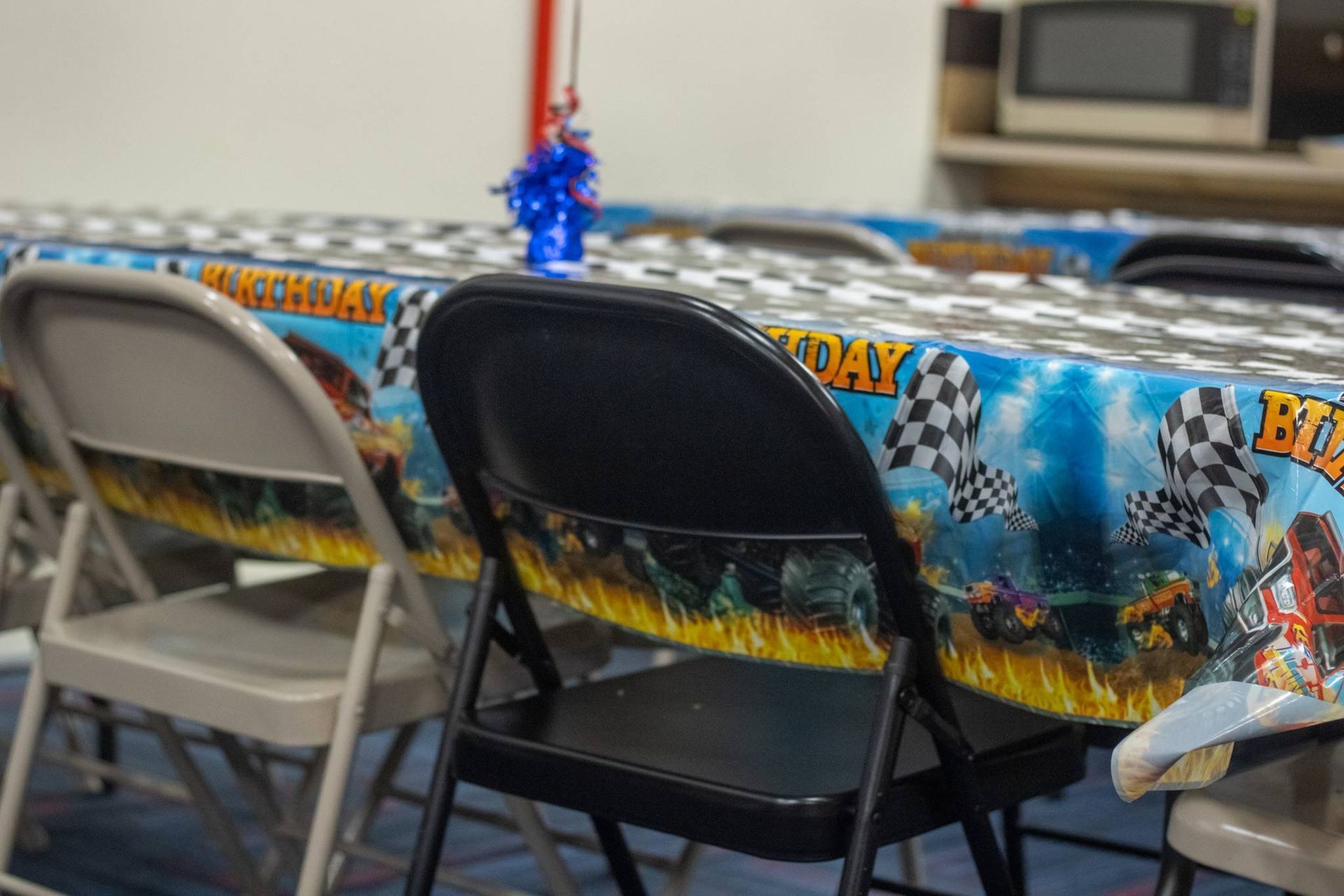 A table with a tablecloth that says birthday on it at Impact Fun Zone