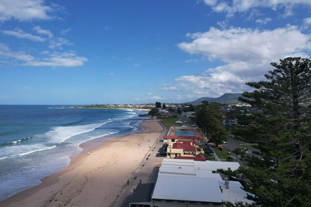 An Aerial View Of A Beach On A Sunny Day— Hume Plumbing & Roofing Wollongong in Thirroul, NSW