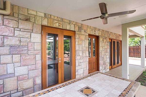 stone exterior with doors with wood framing