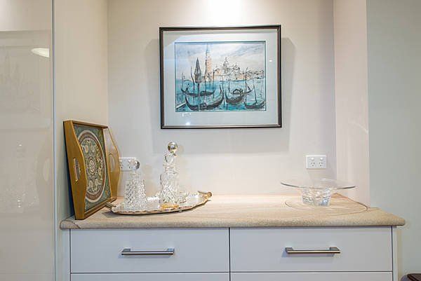 framed picture of boats above dresser