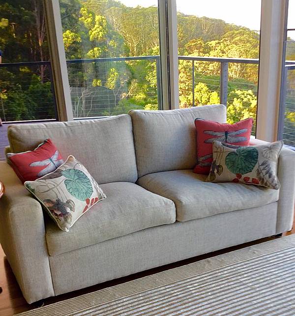 beige sofa in room with accent pillows